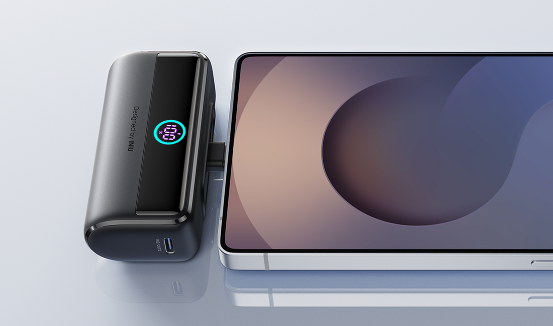 A compact power bank charging a phone via a built-in cable.