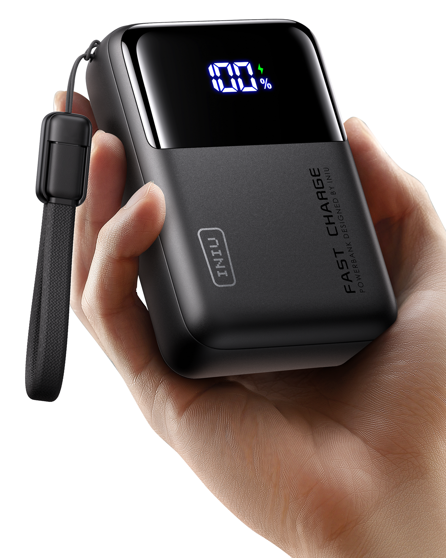 Black power bank with digital display held in a hand on a white background