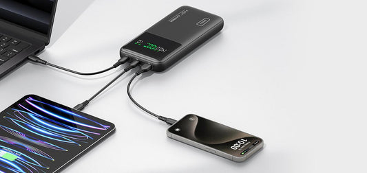 INIU Power Bank charging multiple devices. Laptop, tablet, and phone charging simultaneously with fast charging.